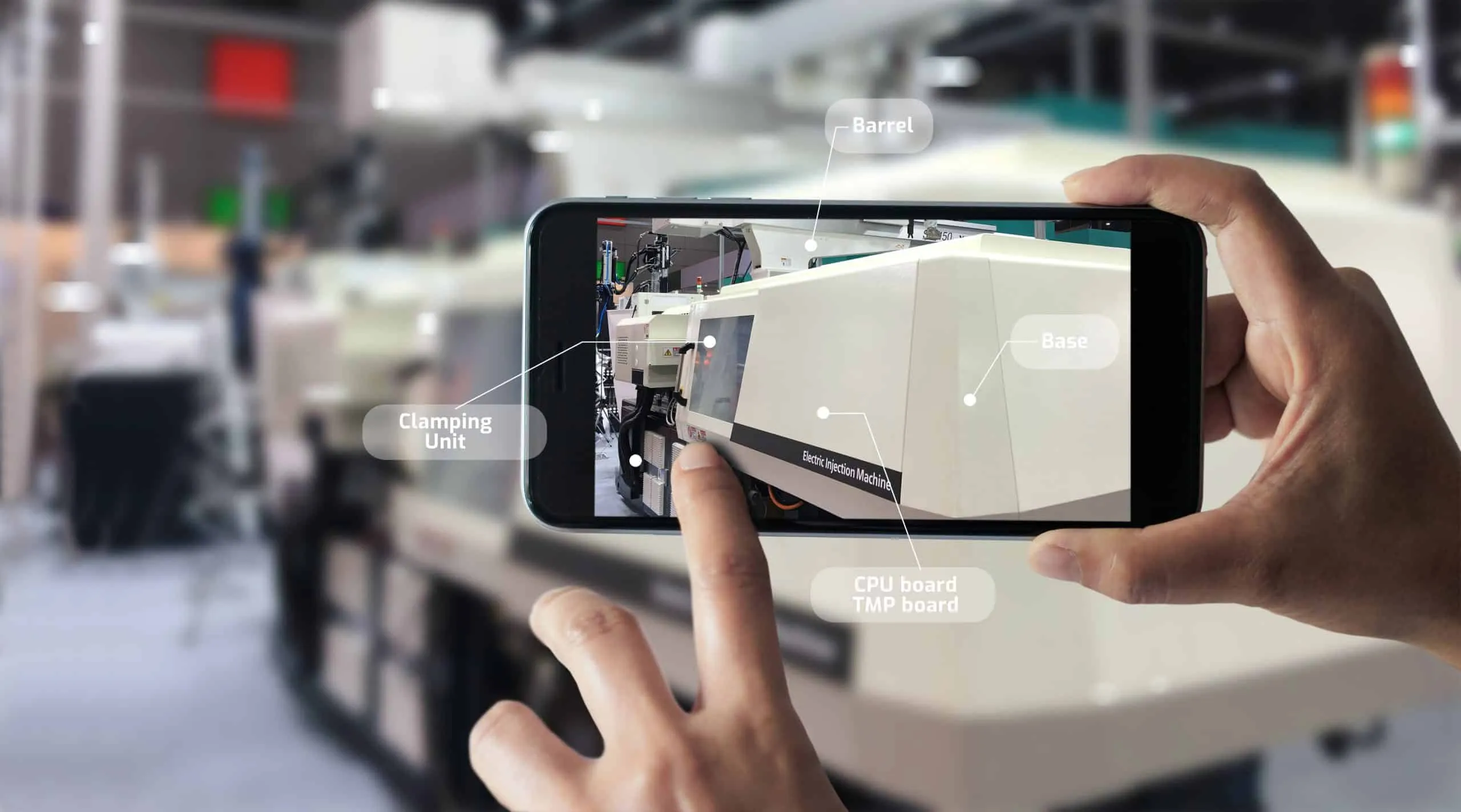 Smartphone camera showing an injection moulding machine in a factory hall, overlaid with labels for individual machine parts