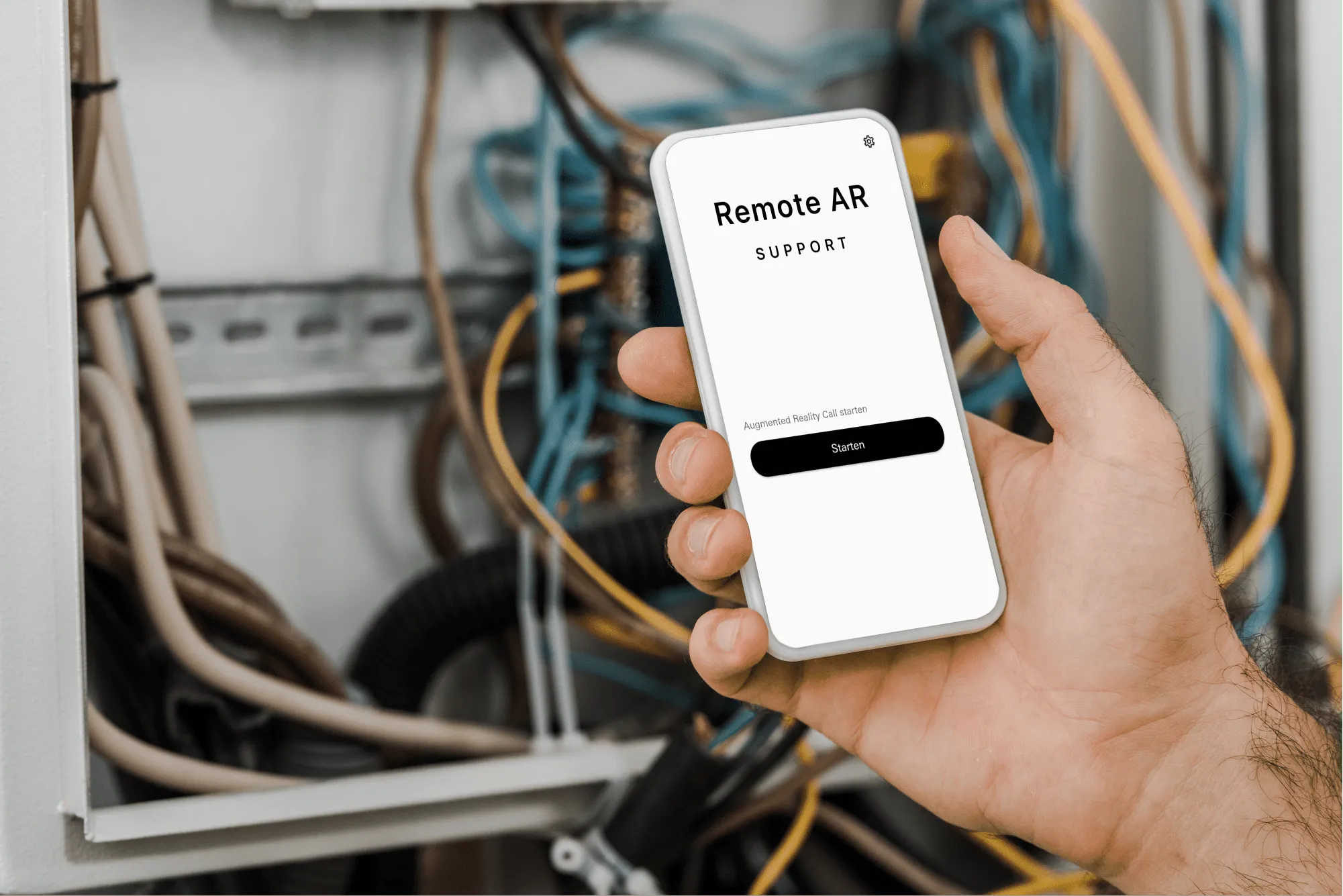 A hand holds a phone in front of an open electrical cabinet; the app offers to start an augmented reality call