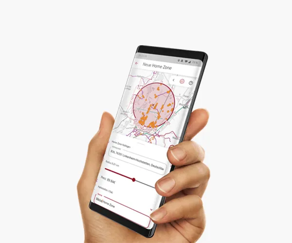 A hand holds a phone showing the KVV Homezone app: a map with radius and price